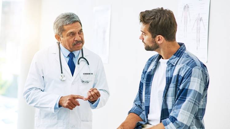 doctor having a disucssion with a male patient